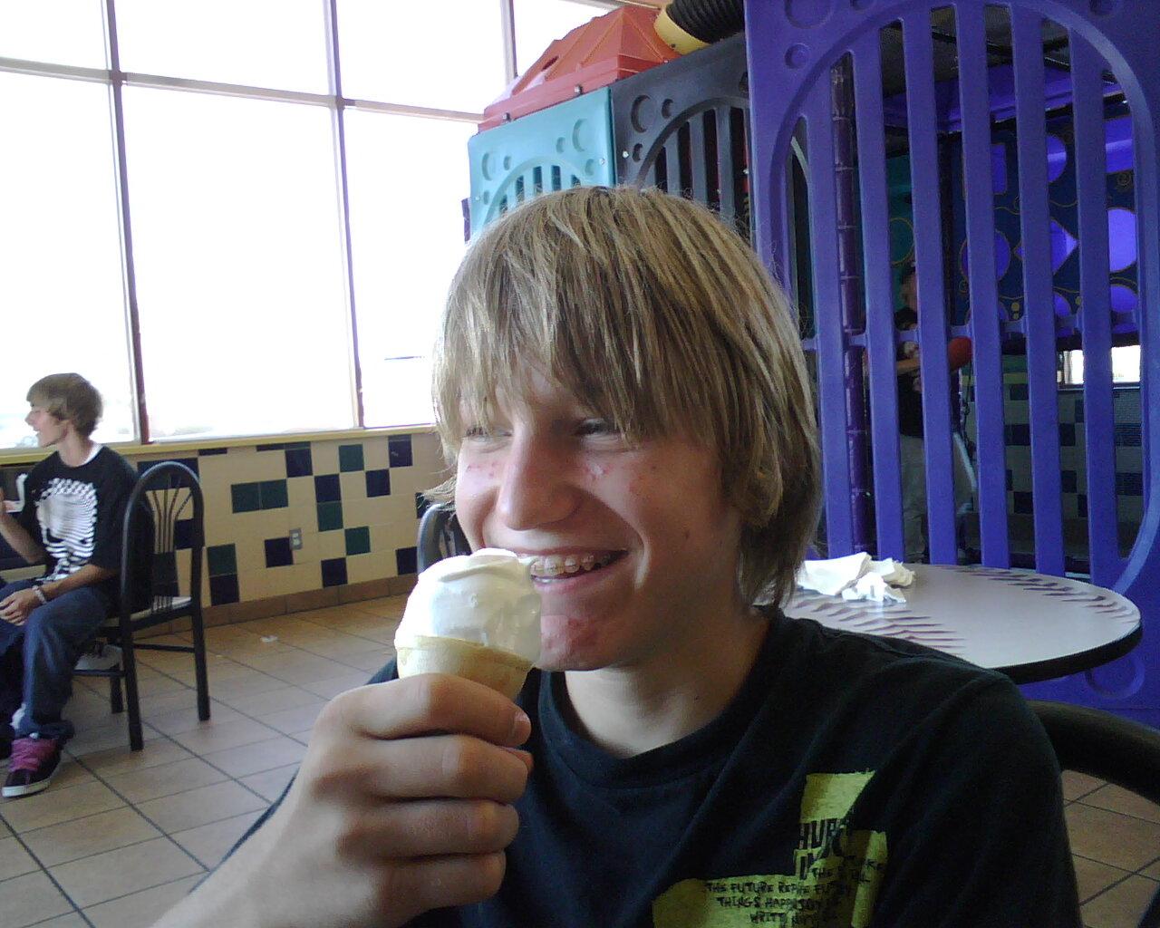 Hayden laughs while eating some ice cream